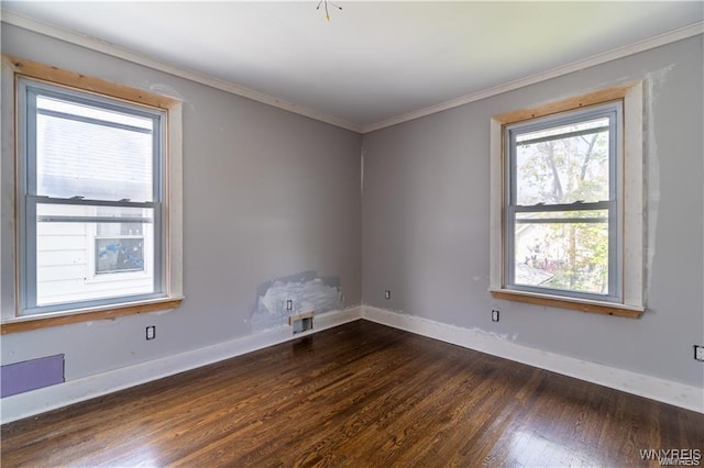 empty room featuring crown molding and dark hardwood / wood-style floors