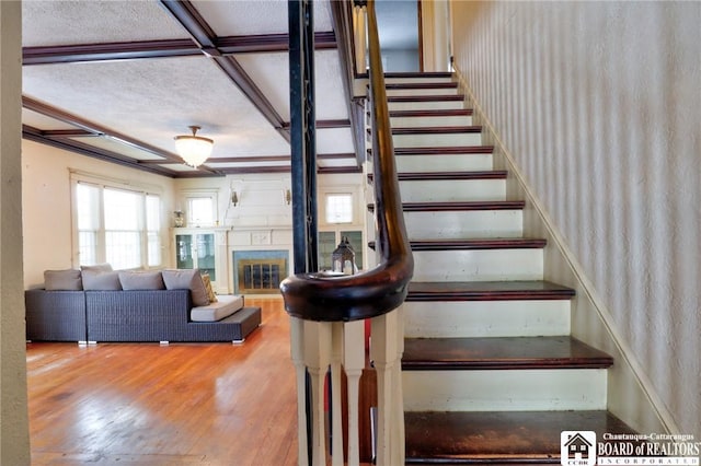 stairway featuring hardwood / wood-style flooring and a textured ceiling