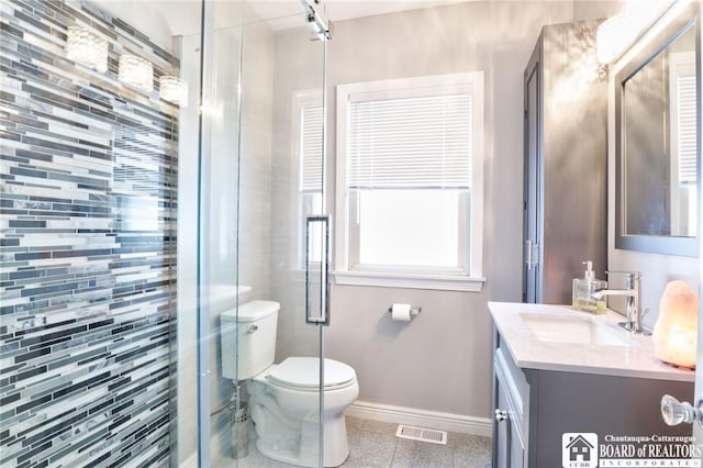 bathroom featuring vanity, toilet, and an enclosed shower