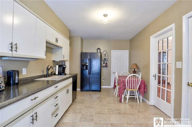 kitchen with sink, black appliances, and white cabinets