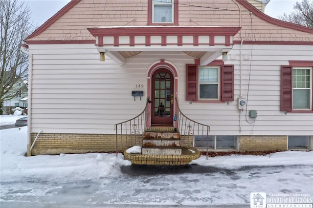 view of snow covered property entrance