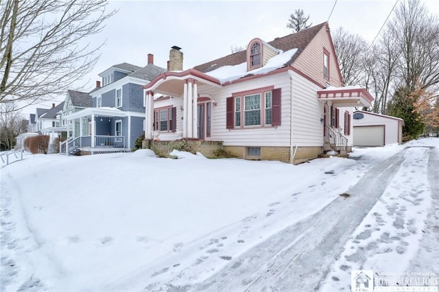 view of front of house featuring a garage and an outdoor structure