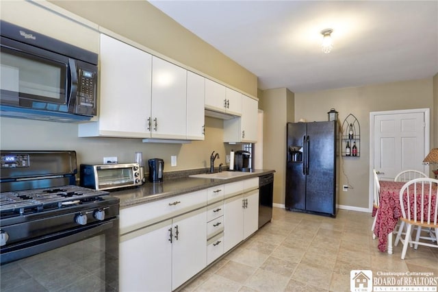 kitchen featuring sink, white cabinets, and black appliances