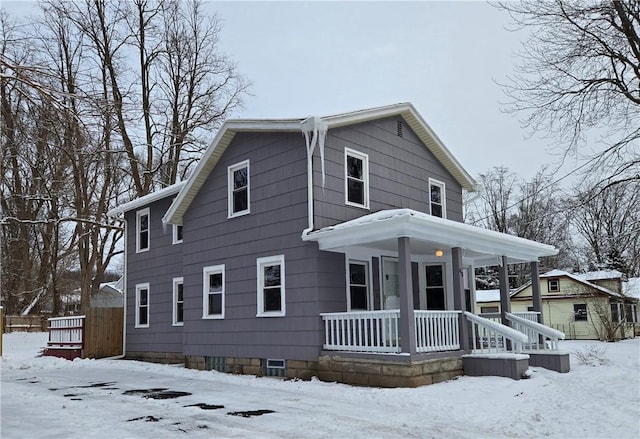 view of front of home with a porch and a shed