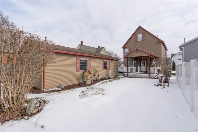 snow covered house with covered porch