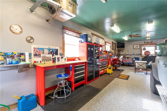 interior space featuring black fridge, ceiling fan, and a workshop area