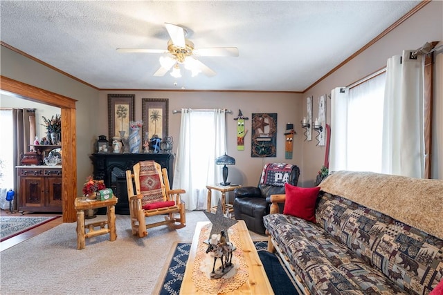 carpeted living room featuring crown molding, a textured ceiling, and a healthy amount of sunlight