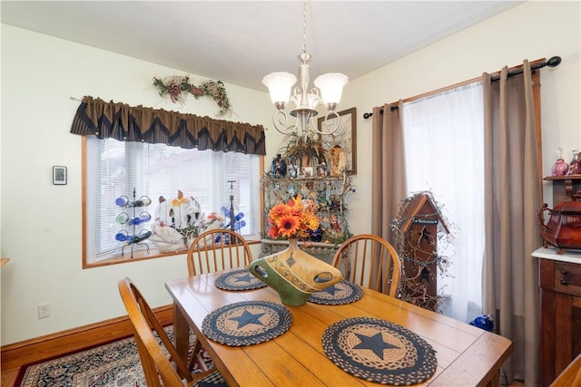 dining space featuring an inviting chandelier and wood-type flooring