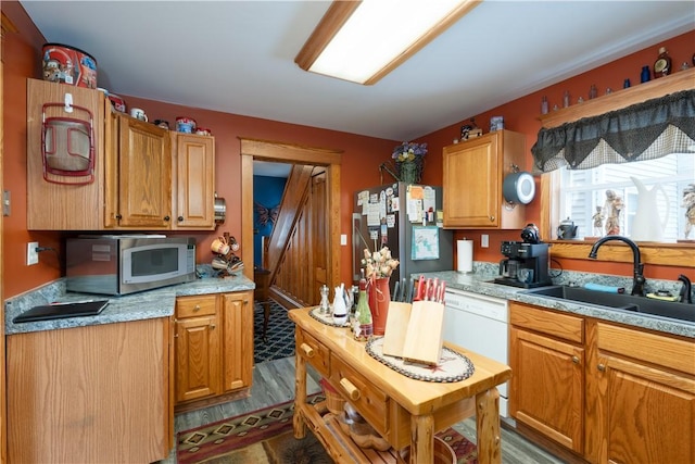 kitchen with sink, dark hardwood / wood-style floors, and appliances with stainless steel finishes