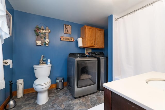 bathroom with washing machine and dryer, vanity, and toilet