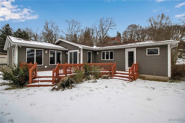 view of snow covered rear of property