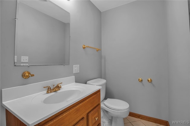 bathroom with tile patterned floors, vanity, and toilet