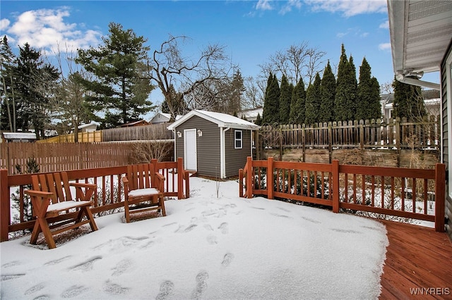 snow covered deck with a storage unit