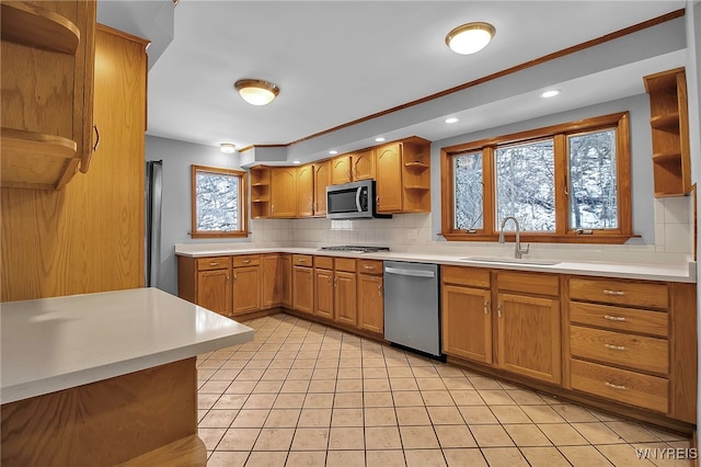 kitchen featuring light tile patterned flooring, appliances with stainless steel finishes, sink, and decorative backsplash