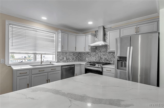 kitchen with wall chimney exhaust hood, stainless steel appliances, sink, and light stone counters