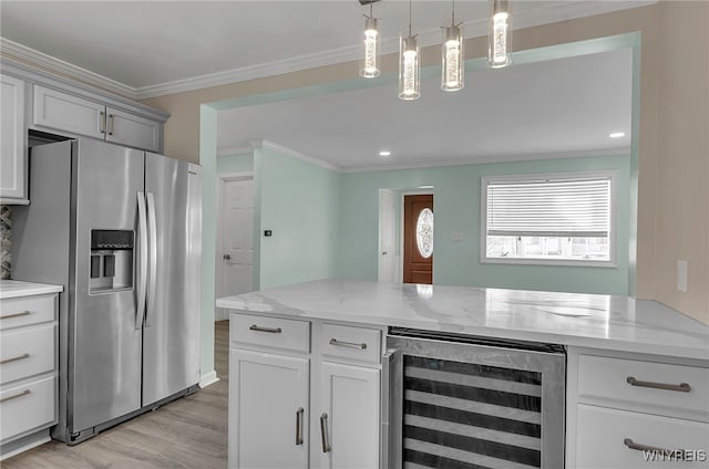 kitchen with wine cooler, stainless steel fridge, light stone countertops, and hanging light fixtures