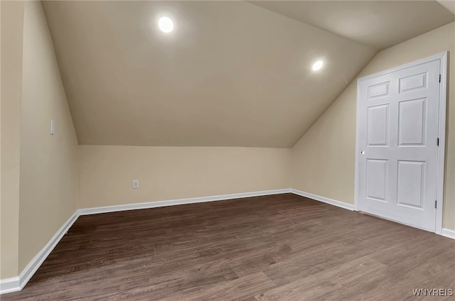 bonus room with wood-type flooring and vaulted ceiling