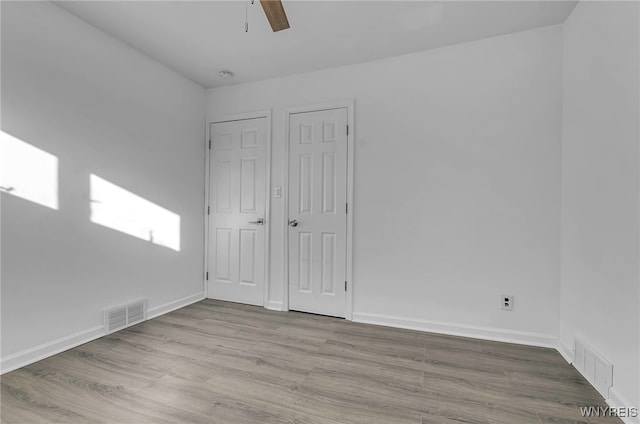 unfurnished bedroom featuring ceiling fan and light hardwood / wood-style flooring