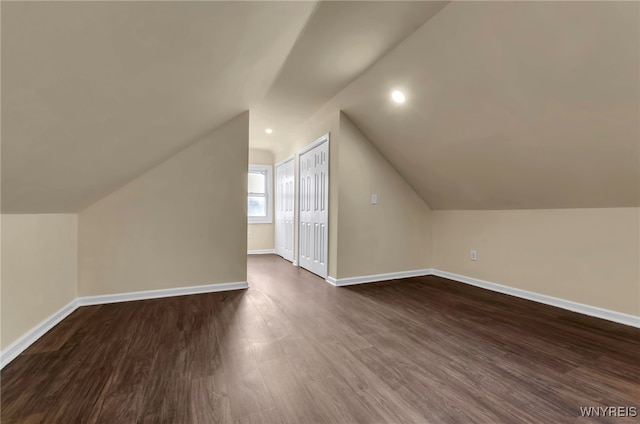 bonus room featuring dark hardwood / wood-style flooring and lofted ceiling