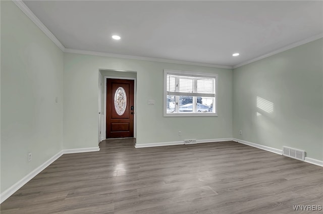 foyer entrance featuring ornamental molding and light hardwood / wood-style flooring