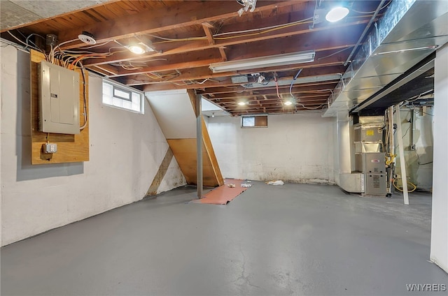 basement featuring heating unit and electric panel