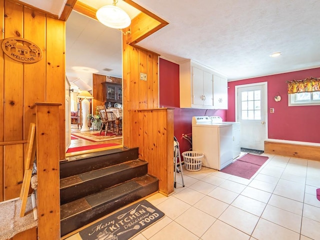 interior space featuring washer and clothes dryer and wood walls