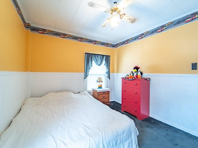 carpeted bedroom featuring ornamental molding and ceiling fan