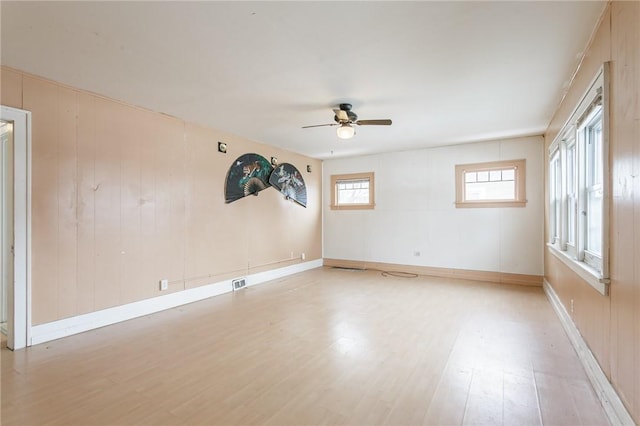 empty room featuring ceiling fan and light hardwood / wood-style floors