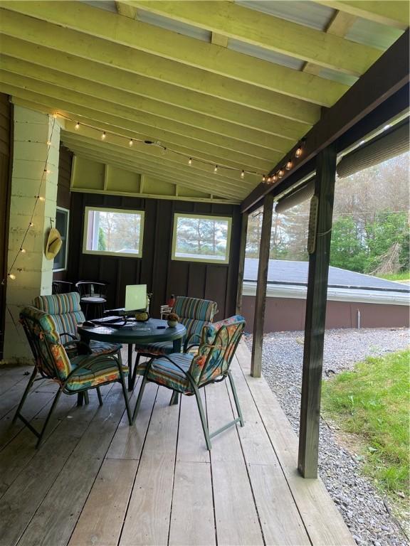 sunroom / solarium featuring vaulted ceiling