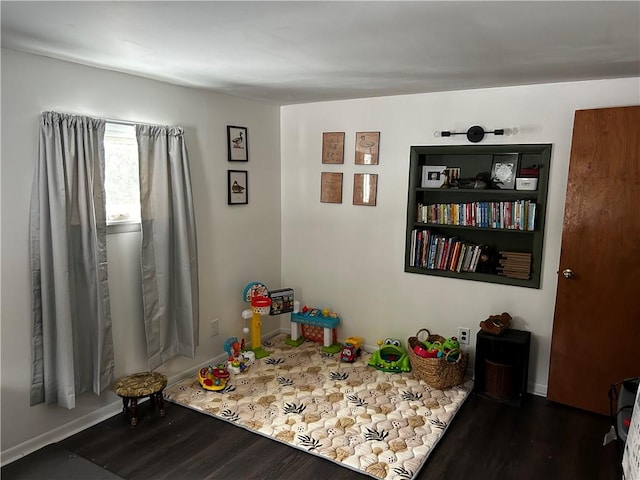 recreation room with dark hardwood / wood-style flooring