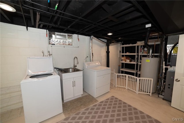 laundry area featuring independent washer and dryer, sink, cabinets, and water heater