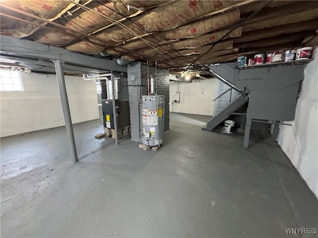 basement featuring water heater and heating unit