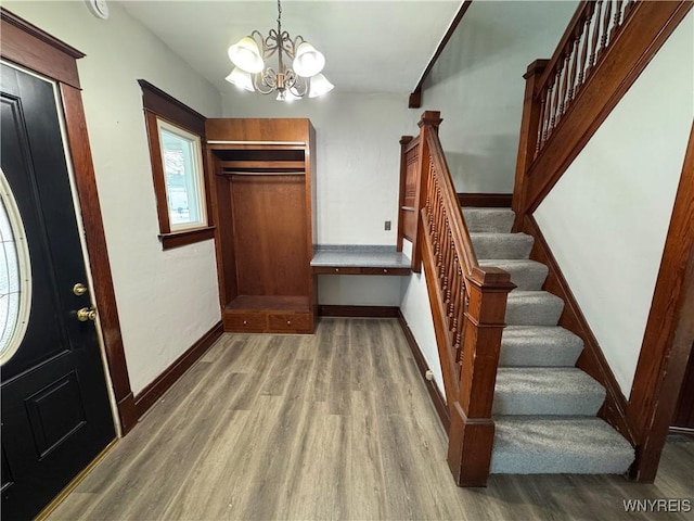 foyer entrance featuring a notable chandelier and light hardwood / wood-style floors