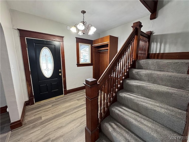 entryway with a chandelier and light hardwood / wood-style floors