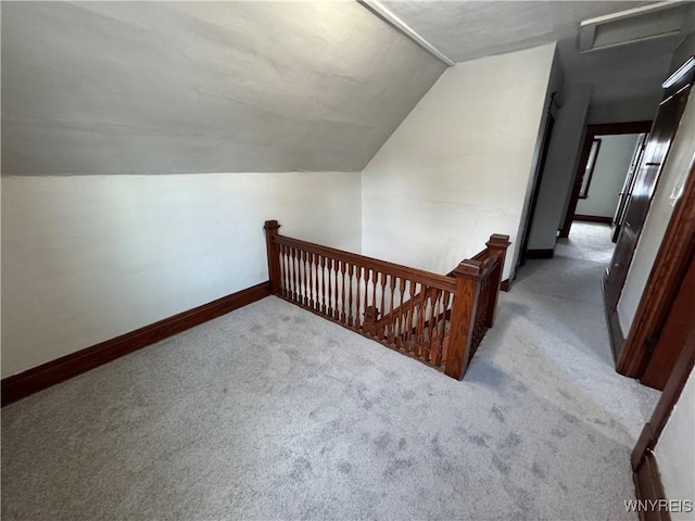 bonus room featuring lofted ceiling and light colored carpet