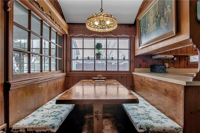 dining area with breakfast area and wooden walls