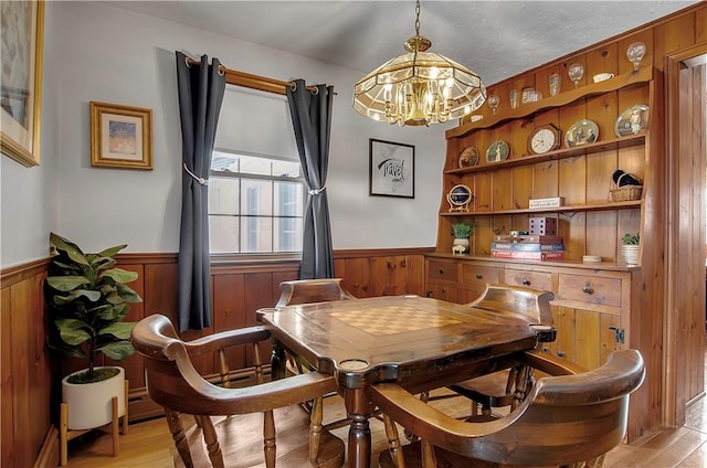 dining area featuring light hardwood / wood-style floors and a notable chandelier