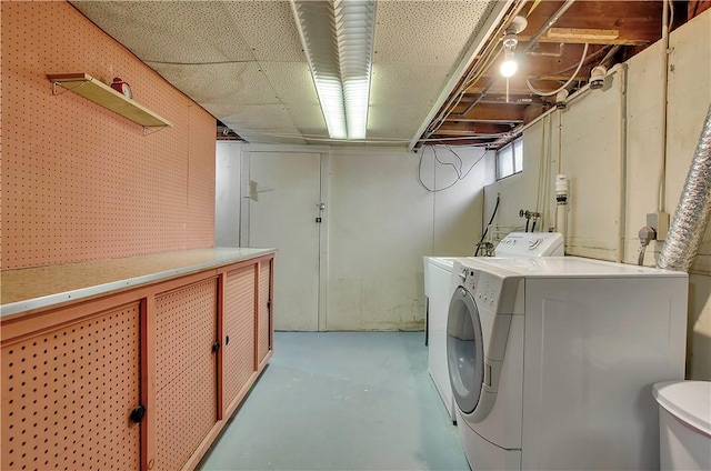 clothes washing area with separate washer and dryer