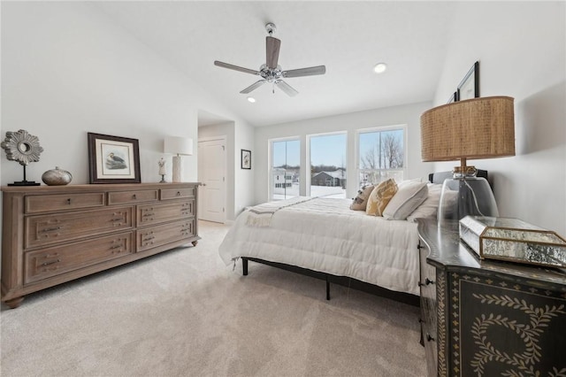 bedroom with ceiling fan, light colored carpet, and high vaulted ceiling