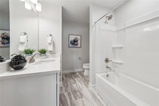 full bathroom with shower / bath combination, vanity, hardwood / wood-style flooring, and toilet