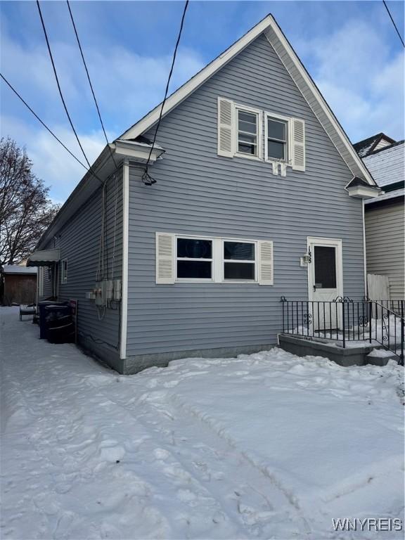 view of snow covered rear of property