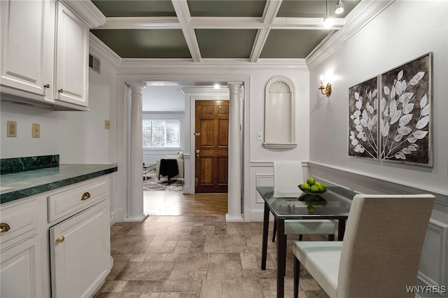 interior space featuring coffered ceiling, beam ceiling, ornamental molding, and decorative columns