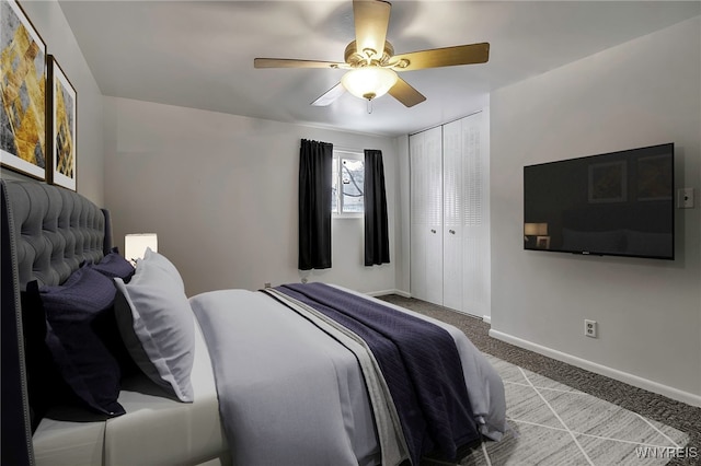 carpeted bedroom featuring ceiling fan and a closet