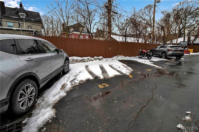 view of snow covered parking area