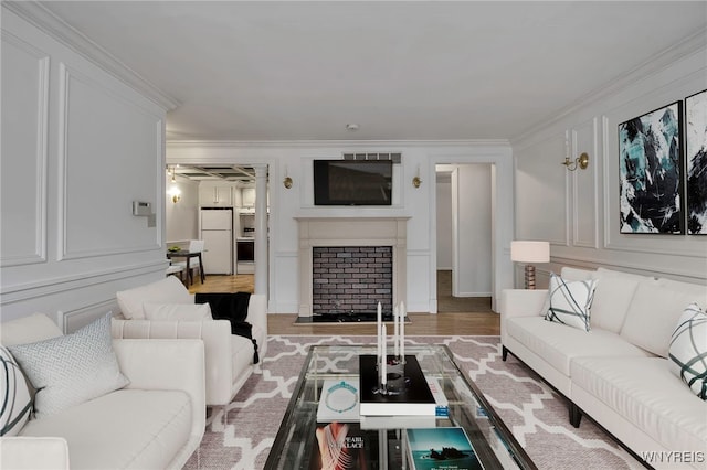 living room with crown molding and light hardwood / wood-style floors