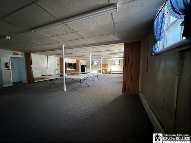 rec room featuring a baseboard heating unit, a paneled ceiling, and carpet