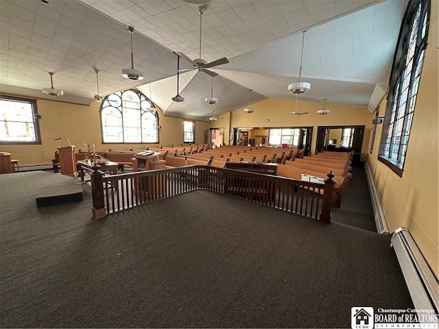 misc room featuring baseboard heating and vaulted ceiling