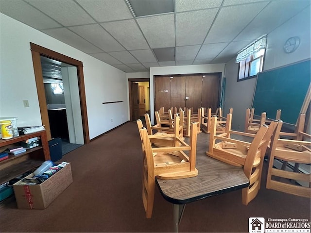 dining area with carpet and a drop ceiling