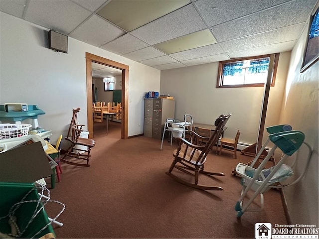 interior space featuring a drop ceiling and carpet