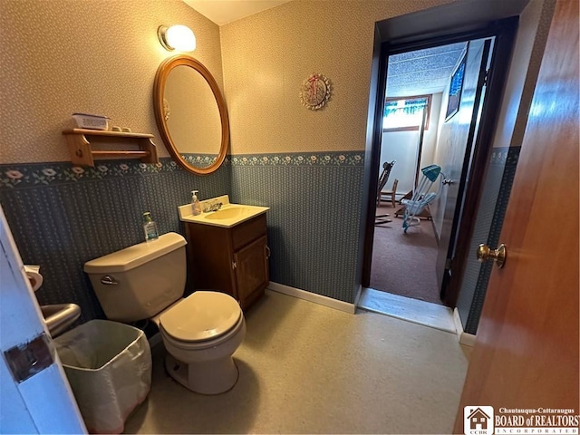 bathroom featuring vanity and toilet